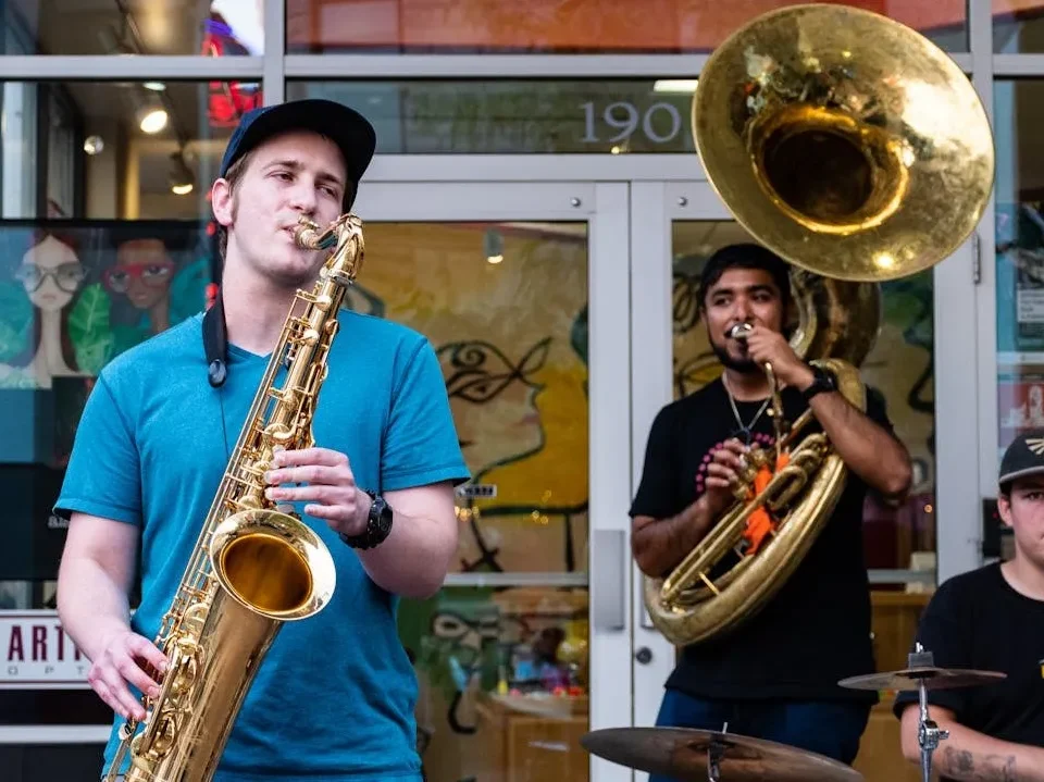 Image of a a saxophonist and tuba player