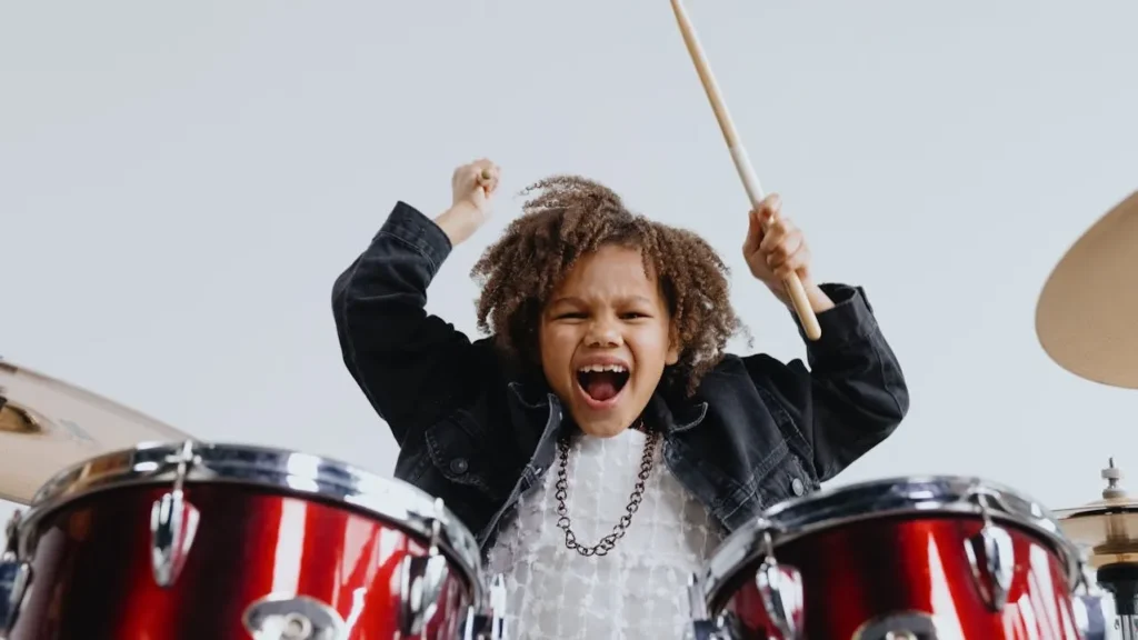 Kid drummer having fun and swinging sticks