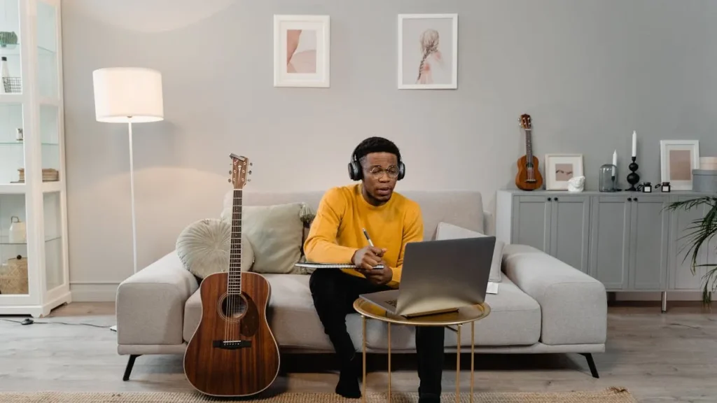 Musicians sitting on the sofa and planning using laptop