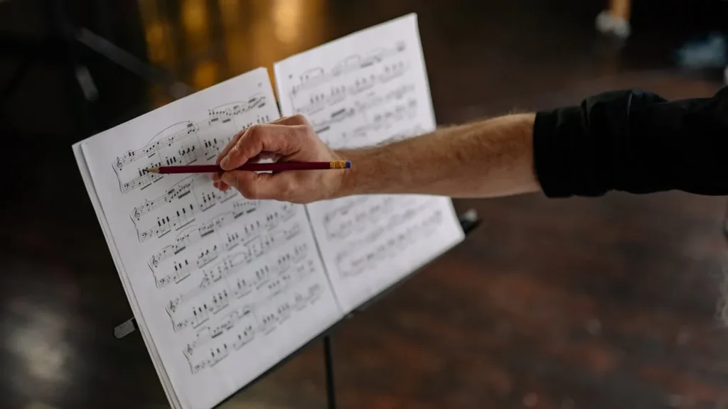 Image of musician writing on scoresheet