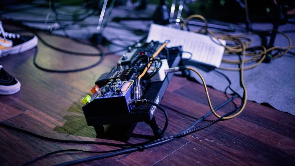 Image of a guitar pedalboard on stage