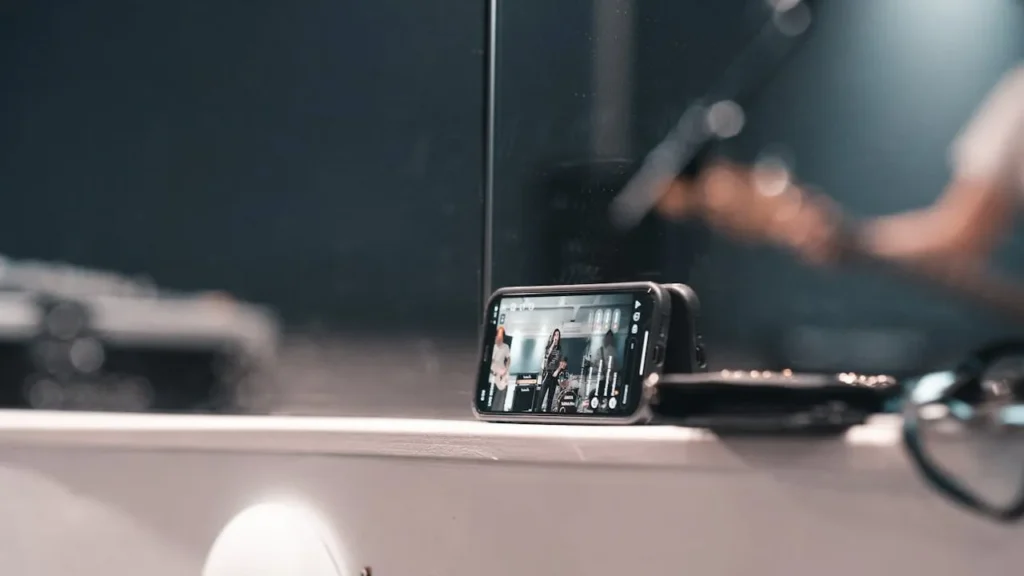 Image of phone recording a video of a band