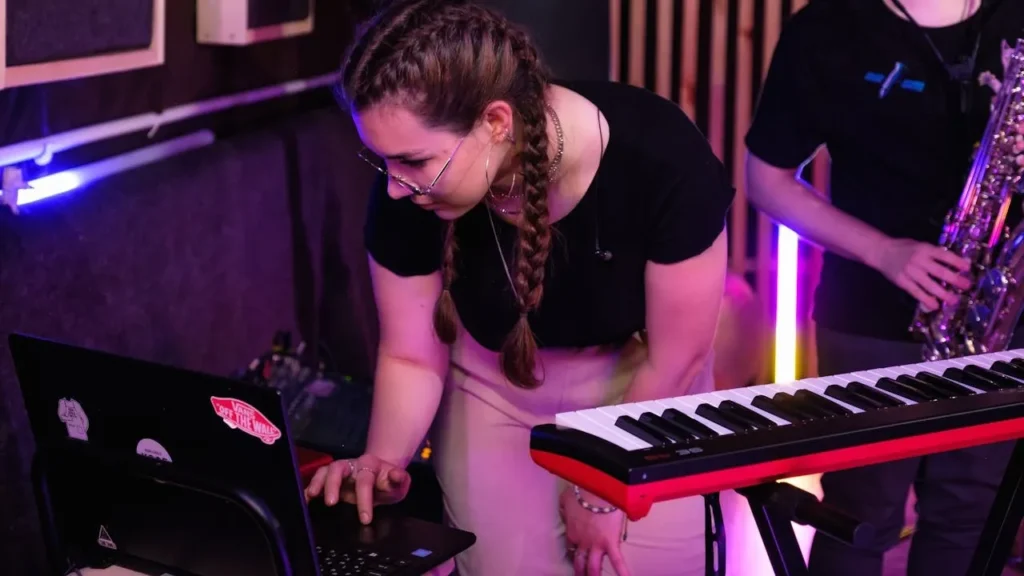 Image of band leader looking at laptop