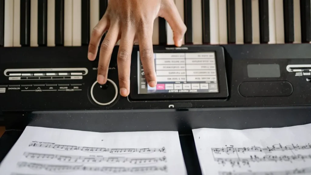 Image of keyboardist adjusting settings on keyboard